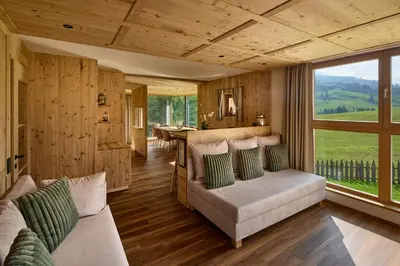 a living room with a couch and a table at Chalet La Varieté in La Villa