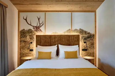 a bedroom with a bed with a deer headboard at Chalet La Varieté in La Villa