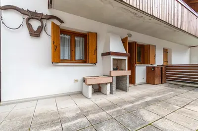 a room with a bench on the side of a building at Appartamento Boè Arabba in Livinallongo del Col di Lana