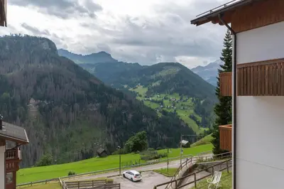 a view of a valley with a car on a road at Appartamento Boè Arabba in Livinallongo del Col di Lana