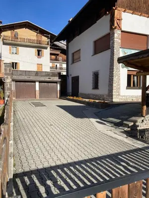 an empty courtyard with a building in the background at Appartamento Canes in Falcade