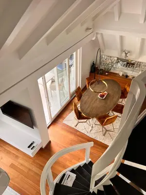 a dining room with a table and chairs at Penthousetraum im Herzen Merans in Merano