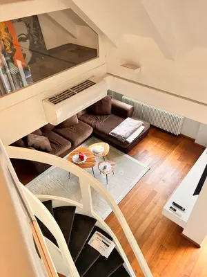 a living room with a couch and a table at Penthousetraum im Herzen Merans in Merano