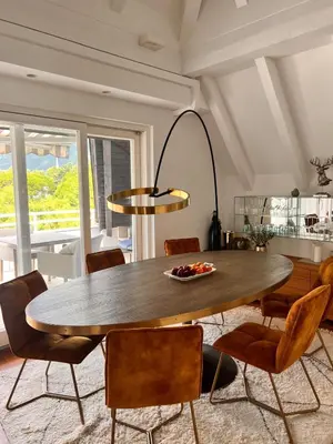 a dining room with a table and chairs at Penthousetraum im Herzen Merans in Merano