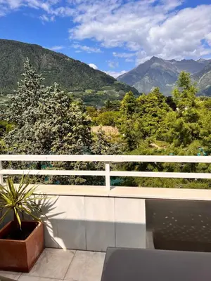 a balcony with a view of the mountains at Penthousetraum im Herzen Merans in Merano