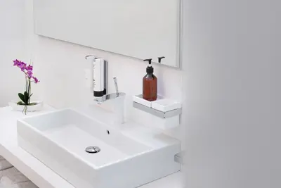a white bathroom with a sink and a mirror at Sweethome Gries - Con Garage in Bolzano