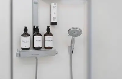 a shelf with three bottles of wine on a wall at Sweethome Gries - Con Garage in Bolzano