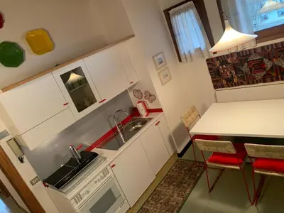 a small kitchen with a sink and a table at Mezzodi in Mareson
