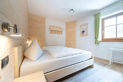 a small bedroom with a bed in a room at Cesa Rosy in Campitello di Fassa