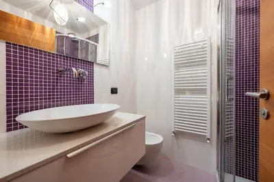a bathroom with a sink and a toilet and a shower at Cesa Rosy in Campitello di Fassa