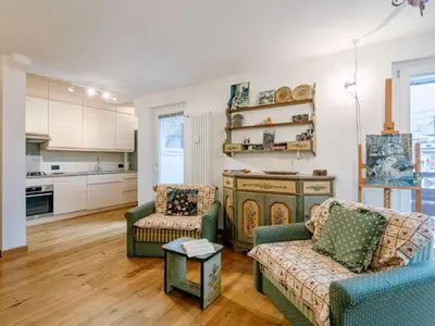 a living room with two couches and a kitchen at Apartment Luisa by Interhome in Canazei