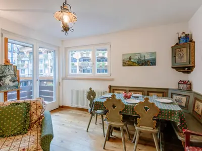 a living room with a table and chairs and a couch at Apartment Luisa by Interhome in Canazei