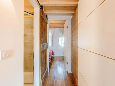 a hallway with wood floors and a door at Apartment Family House by Interhome in Moena