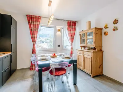 a kitchen with a table with chairs and a window at Apartment Family House by Interhome in Moena