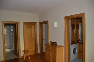 a room with two doors and a washing machine at Apartment with three bedrooms and garden in Chiave in Chiave