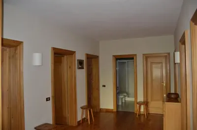 an empty room with three doors and a bathroom at Apartment with three bedrooms and garden in Chiave in Chiave