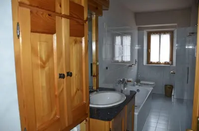 a bathroom with a sink and a toilet and a tub at Apartment with three bedrooms and garden in Chiave in Chiave