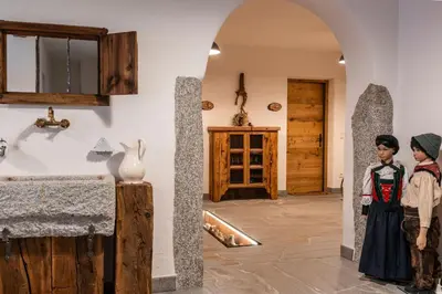 two people are standing in a room with a wall at Weliserhof in Brunico