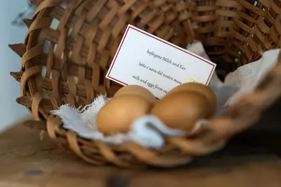 a basket of eggs with a card in it at Weliserhof in Brunico