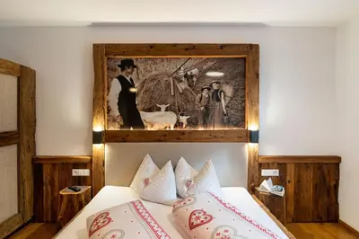 a bedroom with a picture above a bed at Weliserhof in Brunico