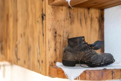 a pair of boots sitting on a shelf at Weliserhof in Brunico
