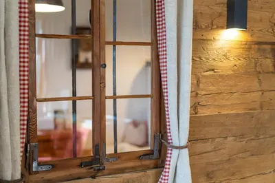 a wooden door with a glass window in a room at Weliserhof in Brunico
