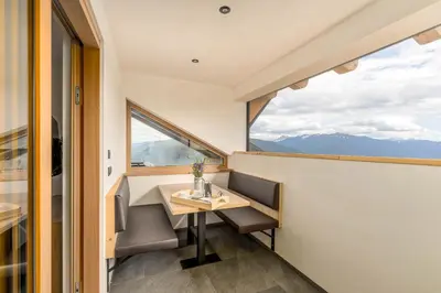 a small village in a green valley with mountains at Appartment Über die Wolken in Maranza