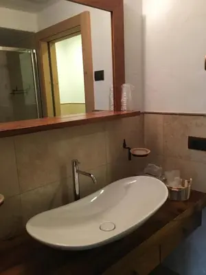 a white sink in a bathroom with a mirror at Agritur el mas in Moena