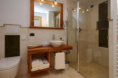 a bathroom with a sink and a shower at Agritur el mas in Moena