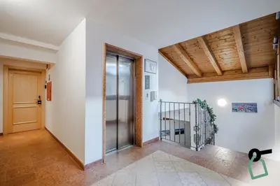 a hallway with white walls and wooden ceilings at HOTIDAY Apartment Collection - Santa Cristina in Santa Cristina in Val Gardena