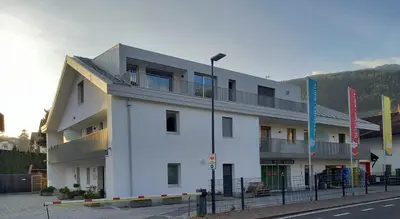 a white building on the side of a street at Apartment Weiss-Spitz in Vipiteno