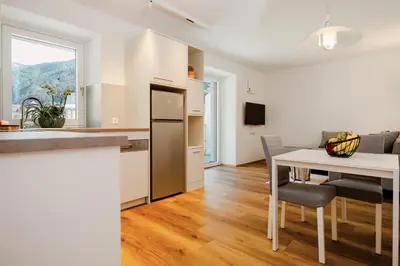 a kitchen and dining room with a table and a dining room at Apartment Weiss-Spitz in Vipiteno