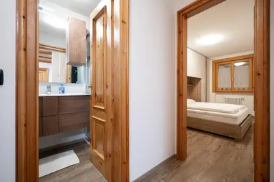 a kitchen with a door leading to a bedroom at Cesa Ricky in Canazei