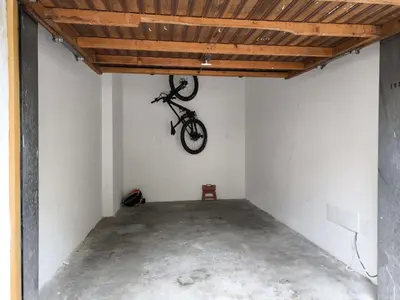 a bike hanging from a ceiling in a garage at Cesa Ricky in Canazei