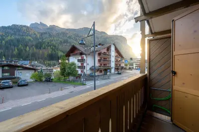 a balcony with a view of a street and mountains at Cesa Ricky in Canazei