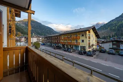 a balcony with a view of a street and buildings at Cesa Ricky in Canazei