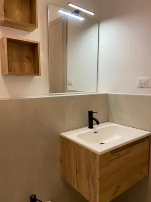 a bathroom with a white sink and a mirror at Luis Home in Laives