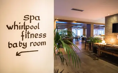 a restaurant with a sign that reads spa withdrawal fitness baby room at Golden Park Resort in Campitello di Fassa