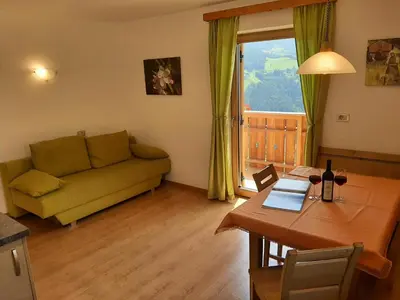 a living room with a couch and a table at Ferienbauernhof Masunerhof in Fiè