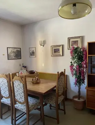 a dining room with a wooden table and chairs at Mountainlodge Sellaronda in Canazei