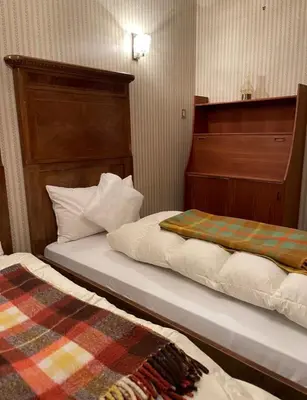two beds sitting next to each other in a room at Mountainlodge Sellaronda in Canazei