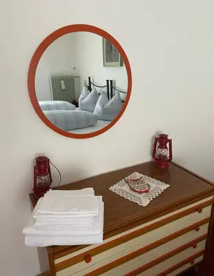 a mirror on a wall above a wooden table at Mountainlodge Sellaronda in Canazei