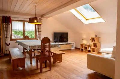 a living room with a table and a couch at Cèsa Cianacei Prestige in Canazei