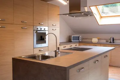 a kitchen with a sink and a stove at Cèsa Cianacei Prestige in Canazei