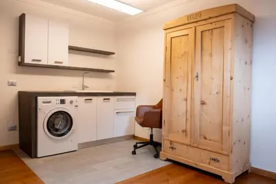 a laundry room with a washing machine and a washer at Cèsa Cianacei Prestige in Canazei