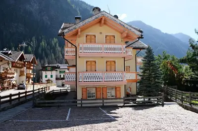 a large house with a balcony on top of it at Casa Bibi in Campitello di Fassa
