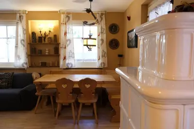 a kitchen and dining room with a wooden table and chairs at Casa Bibi in Campitello di Fassa