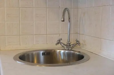 a stainless steel sink with a faucet on a counter at Casa Bibi in Campitello di Fassa