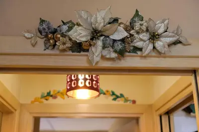 a christmas wreath on top of a door at Casa Bibi in Campitello di Fassa