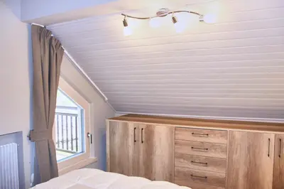 a bedroom with a bed and a window at Cèsa Civetta in Canazei